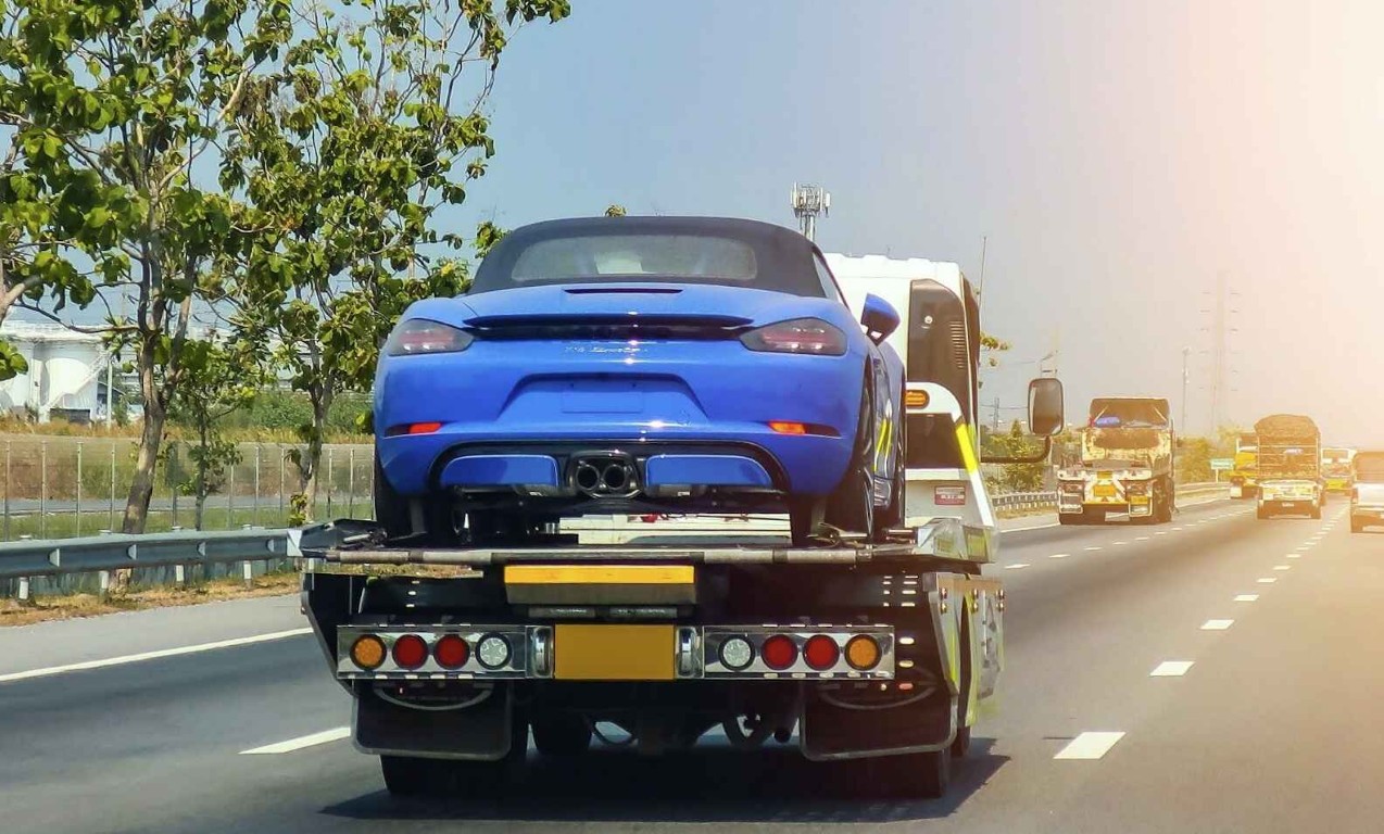 Flatbed towing service transporting luxury sports car safely in Syracuse, UT