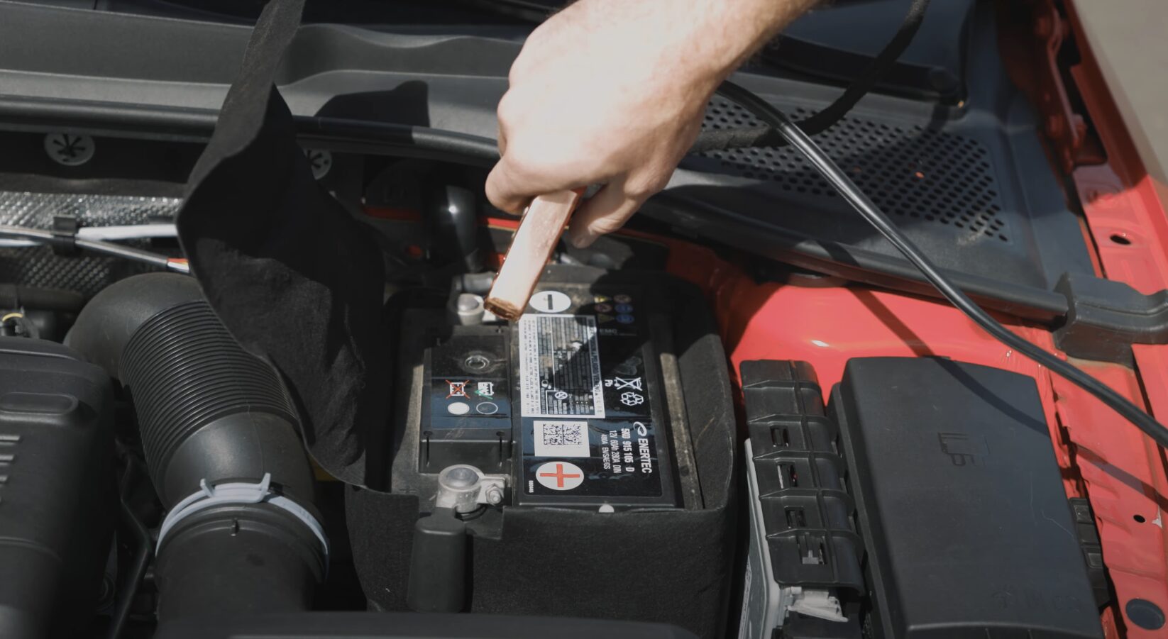 Roadside assistance technician providing battery jump start service in Syracuse UT