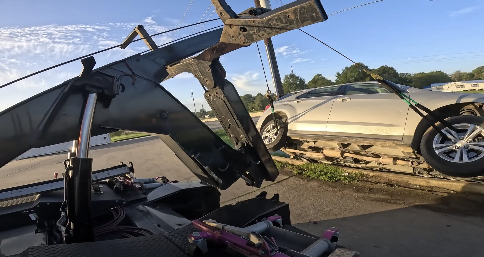 Professional tow truck loading damaged vehicle for emergency towing in Syracuse UT